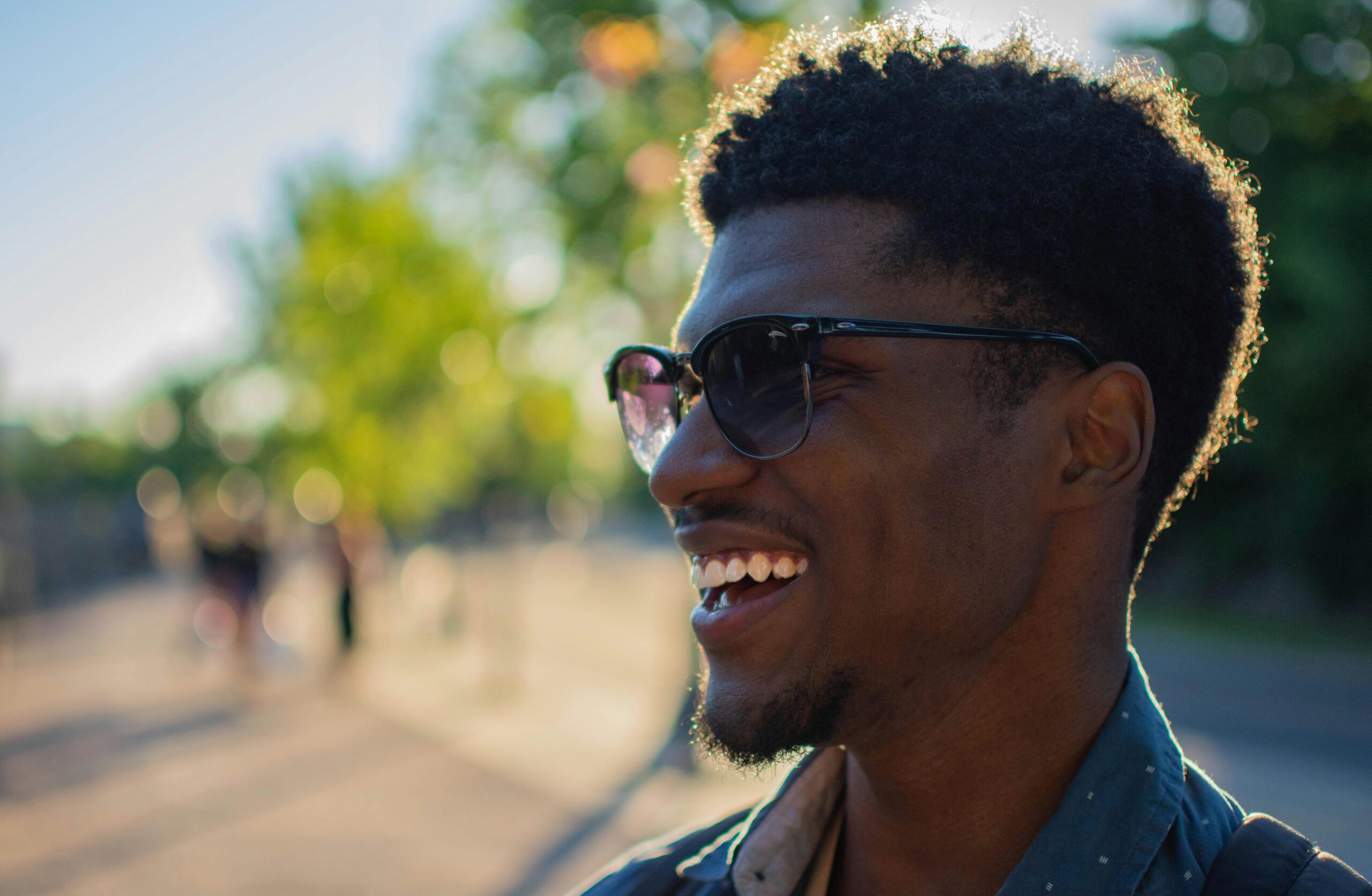 Man Wearing Blue Shirt Smiling Outside